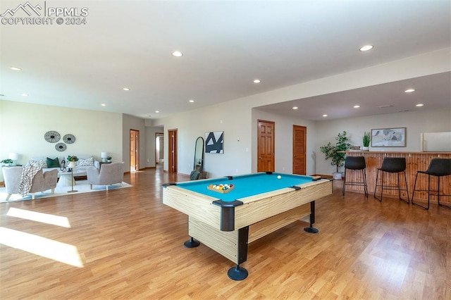 rec room with light hardwood / wood-style flooring, bar, and billiards