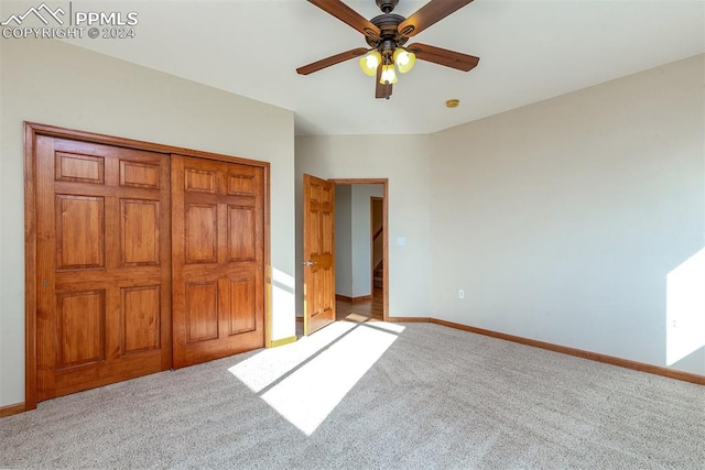 unfurnished bedroom featuring carpet floors, a closet, and ceiling fan