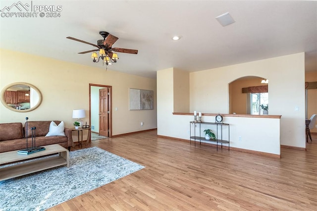 living room featuring light hardwood / wood-style flooring and ceiling fan