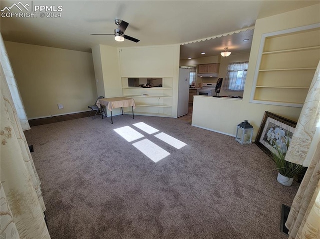 unfurnished living room with carpet flooring, ceiling fan, and built in features