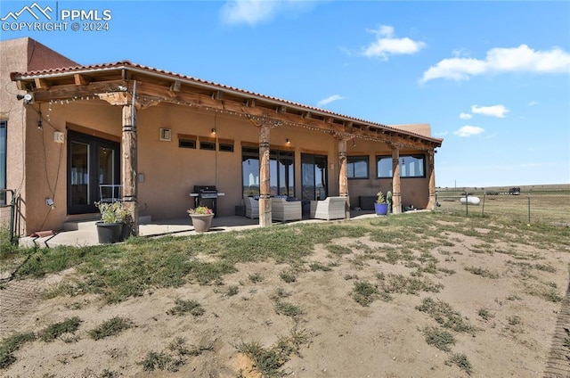 rear view of house featuring a patio