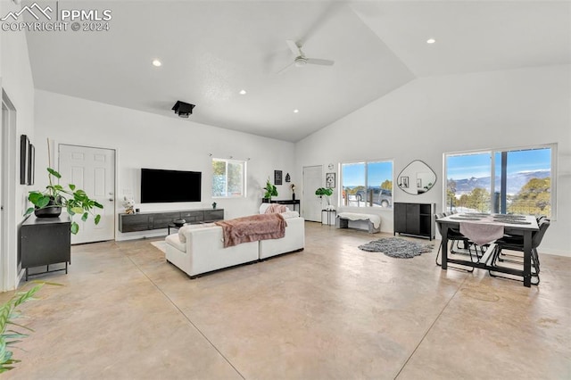 living room with ceiling fan, plenty of natural light, and high vaulted ceiling