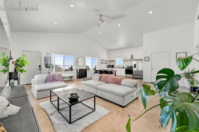 living room with light hardwood / wood-style floors, high vaulted ceiling, and ceiling fan