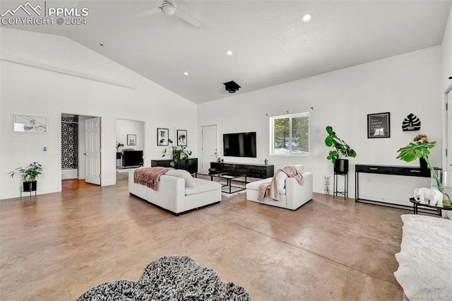 living room featuring ceiling fan, high vaulted ceiling, and concrete floors