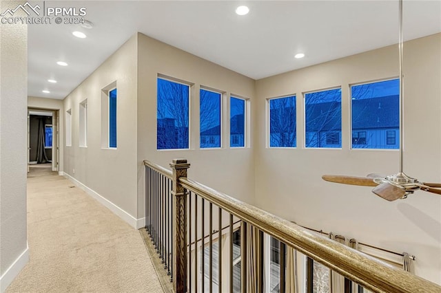 hallway featuring light carpet