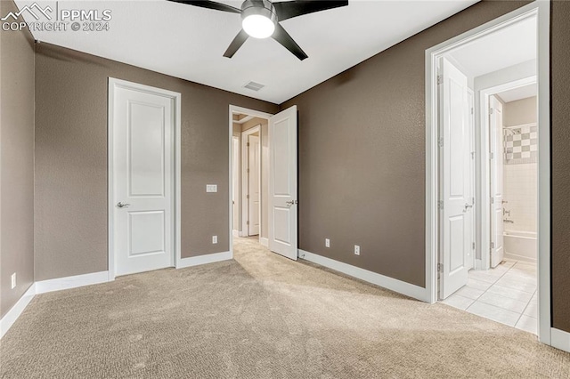 unfurnished bedroom featuring ensuite bathroom, ceiling fan, and light colored carpet