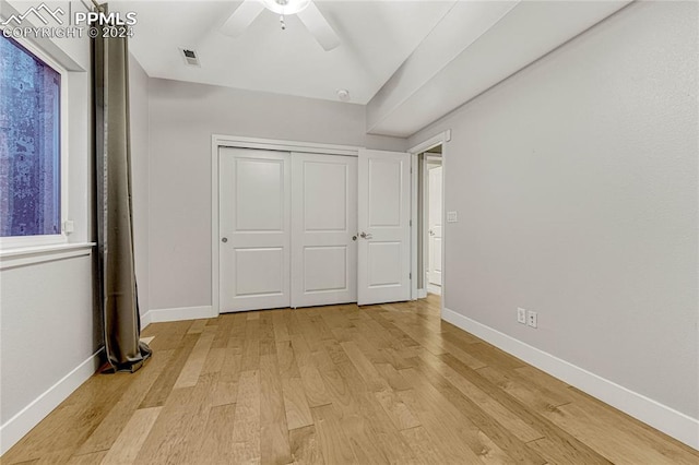 unfurnished bedroom with ceiling fan and light wood-type flooring