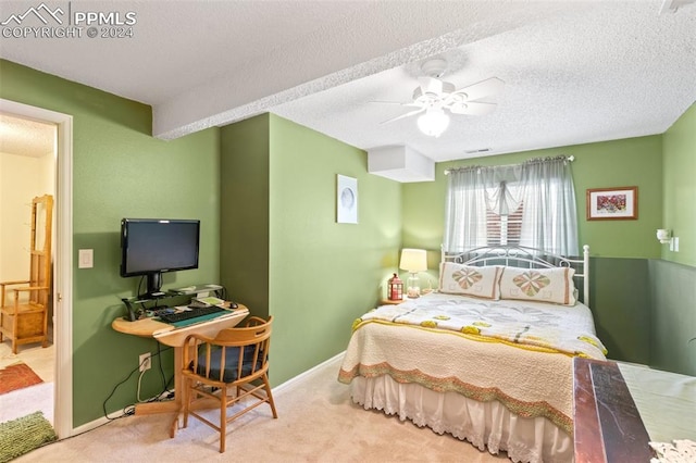 bedroom featuring carpet flooring, ceiling fan, and a textured ceiling