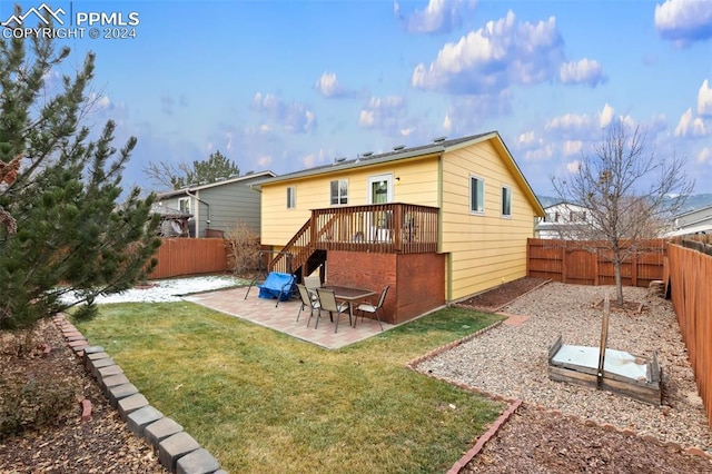 back of house featuring a patio area, a yard, and a deck