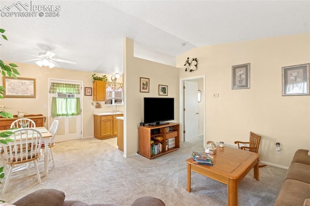 carpeted living room featuring ceiling fan and lofted ceiling