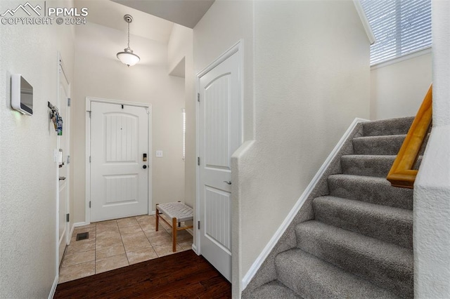 foyer with hardwood / wood-style flooring and vaulted ceiling