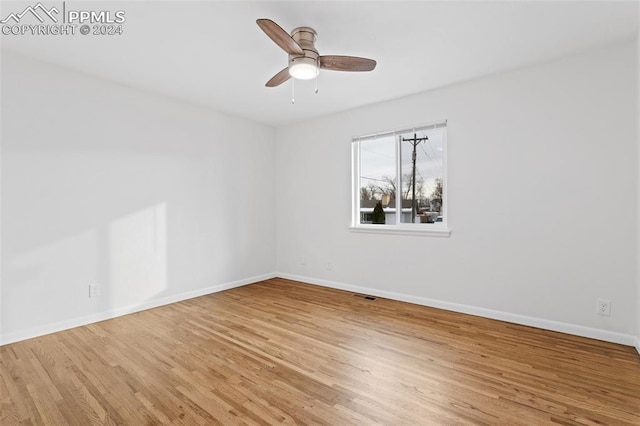 unfurnished room with hardwood / wood-style floors and ceiling fan