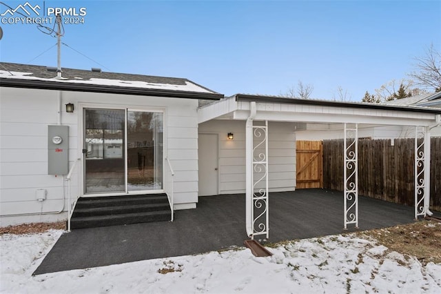 view of snow covered property entrance