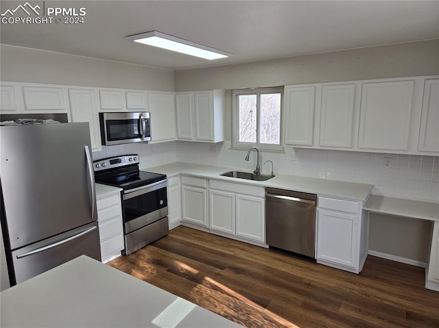 kitchen featuring sink, white cabinetry, stainless steel appliances, and tasteful backsplash