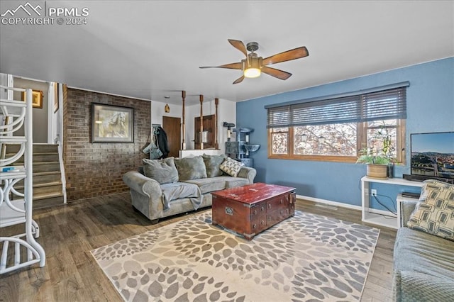 living room with ceiling fan and dark wood-type flooring