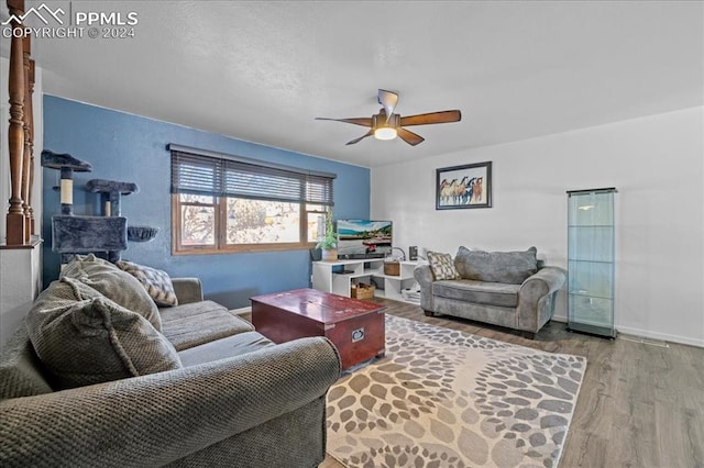 living room featuring ceiling fan and light hardwood / wood-style floors