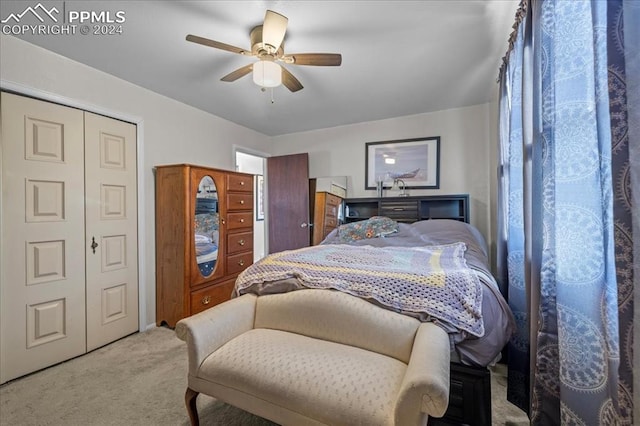 carpeted bedroom featuring ceiling fan and a closet