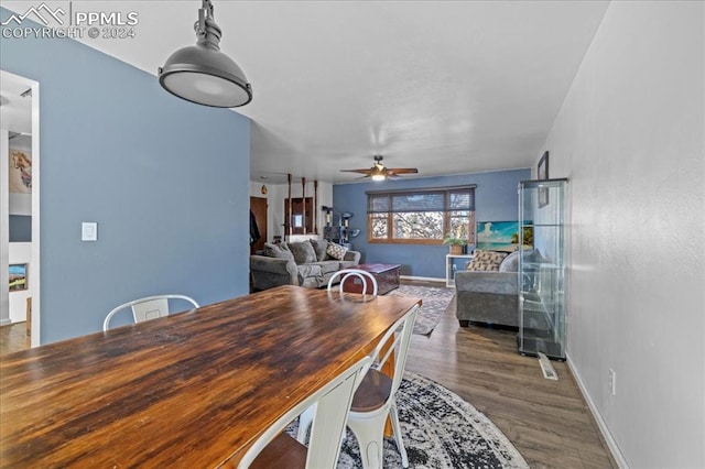 dining area with dark hardwood / wood-style floors and ceiling fan