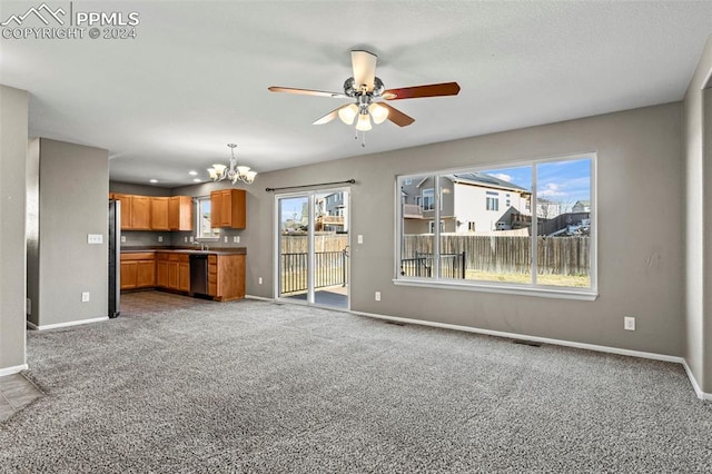 unfurnished living room featuring ceiling fan with notable chandelier, carpet floors, and sink