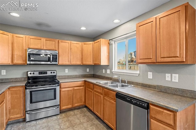 kitchen with sink and appliances with stainless steel finishes