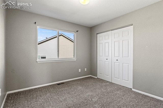 unfurnished bedroom featuring a closet and carpet floors