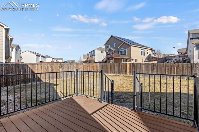 wooden deck featuring a lawn