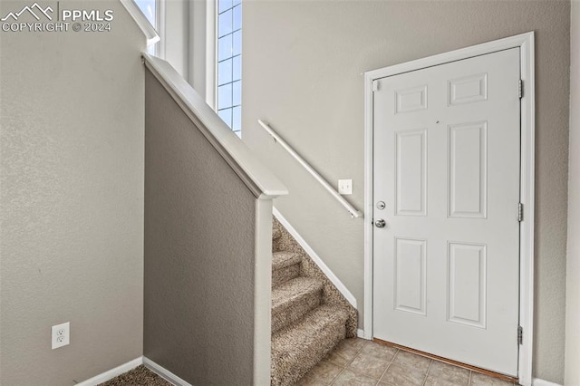 stairs featuring tile patterned flooring