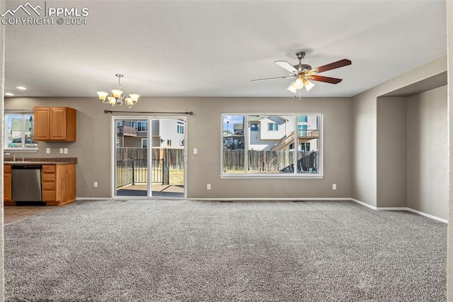 unfurnished living room with carpet, ceiling fan with notable chandelier, and sink