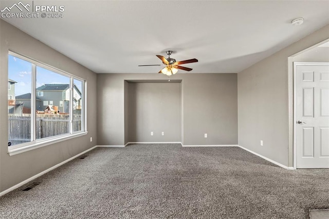 spare room featuring carpet and ceiling fan