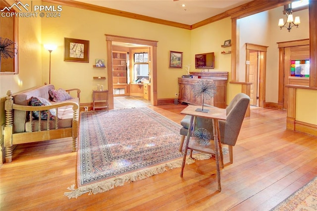 living room with an inviting chandelier, light hardwood / wood-style floors, and ornamental molding