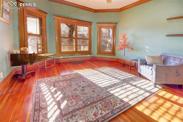 sitting room with crown molding, hardwood / wood-style floors, and ceiling fan