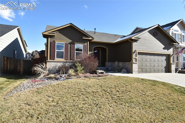 ranch-style home featuring a front lawn and a garage