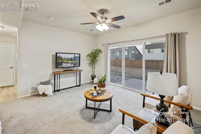 carpeted living room featuring ceiling fan