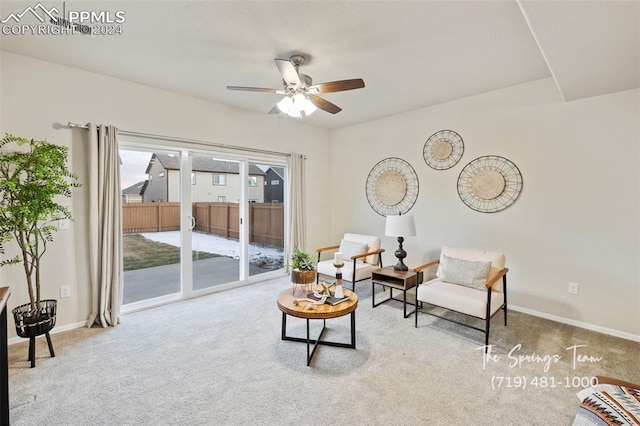 living area with carpet floors and ceiling fan