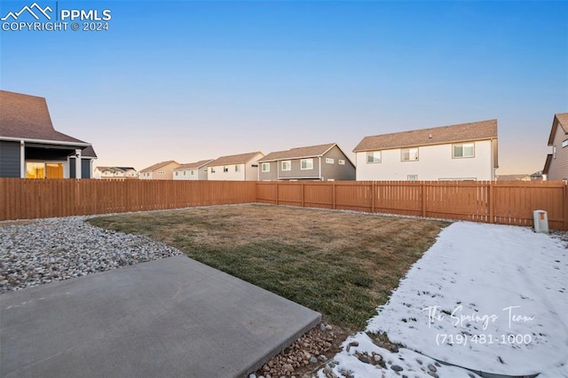 snowy yard with a patio