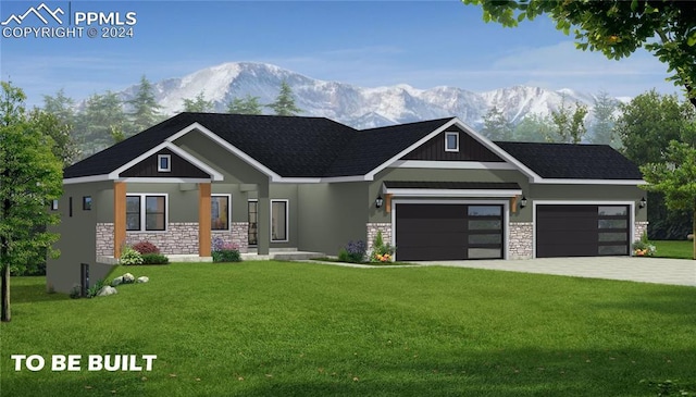 view of front of property featuring a mountain view, a garage, and a front lawn