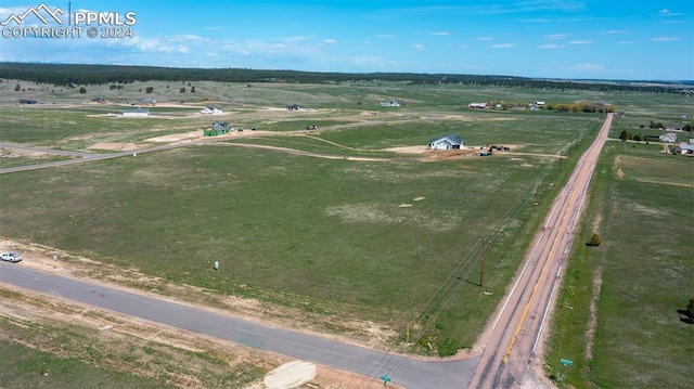 birds eye view of property with a rural view