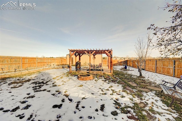 yard covered in snow with a pergola