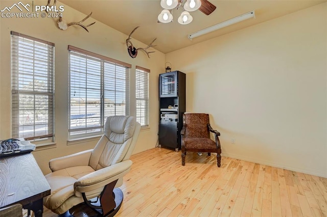 living area featuring ceiling fan and light hardwood / wood-style floors