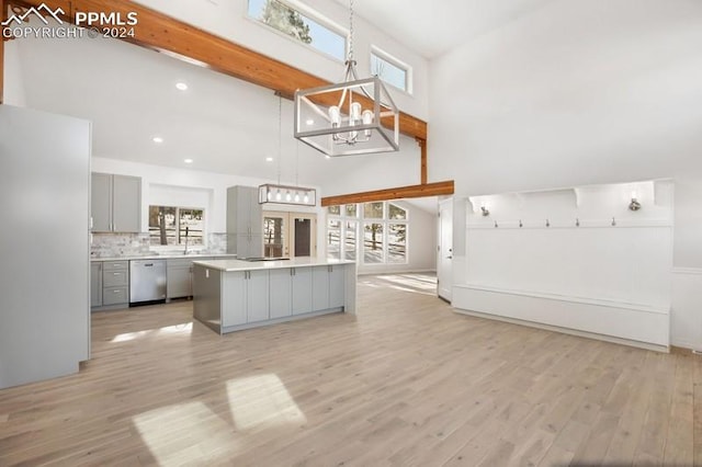 kitchen featuring gray cabinetry, dishwasher, light hardwood / wood-style floors, and a spacious island