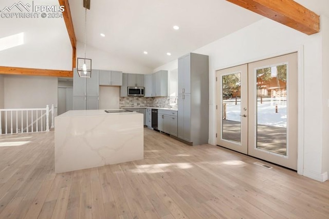 kitchen with light stone countertops, french doors, beam ceiling, decorative light fixtures, and gray cabinets