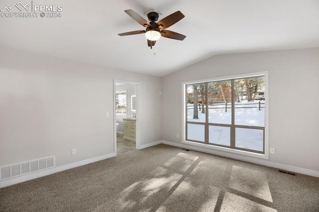 carpeted spare room with ceiling fan and lofted ceiling