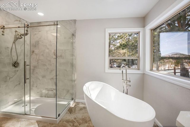 bathroom featuring tile patterned flooring and separate shower and tub