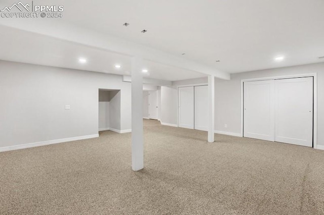 basement featuring light carpet