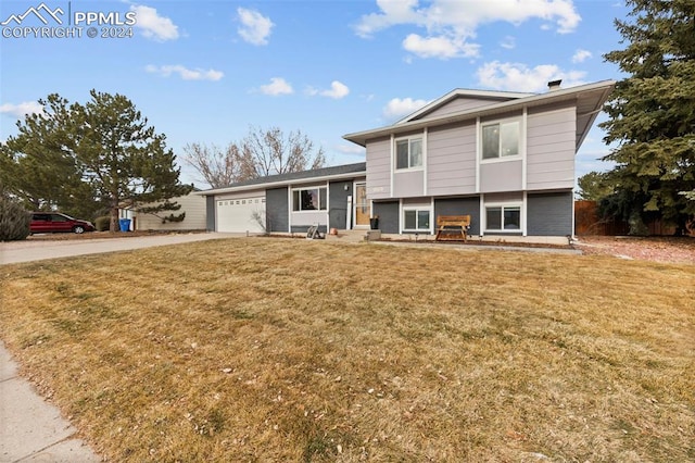 split level home featuring a front yard and a garage