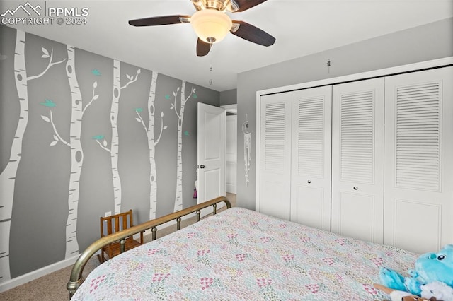 carpeted bedroom featuring ceiling fan and a closet