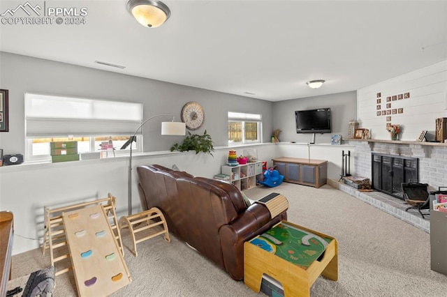 living room featuring light colored carpet and a brick fireplace