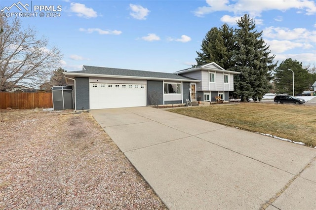 tri-level home featuring a front yard and a garage