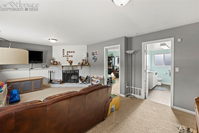 living room with a fireplace and light carpet