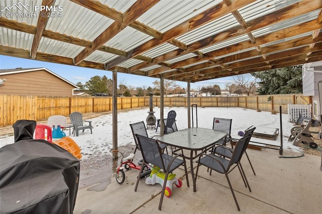 snow covered patio featuring grilling area